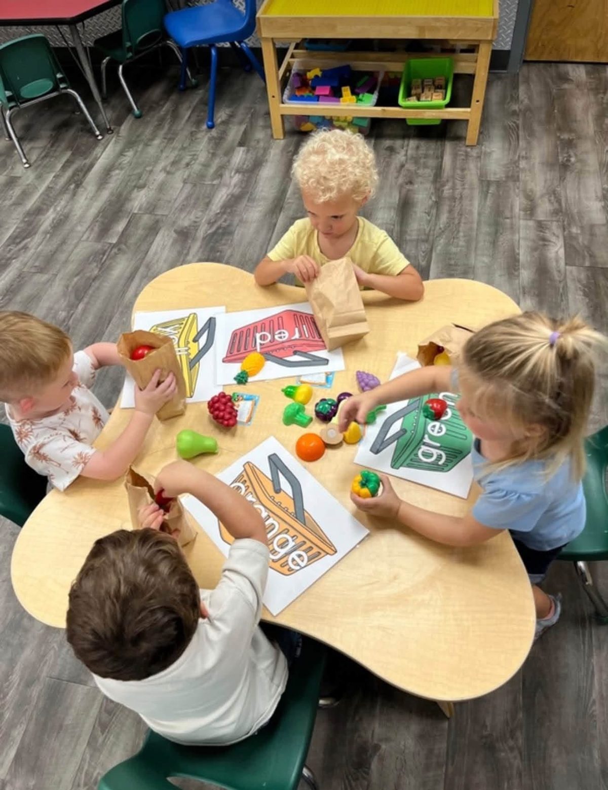 Preschoolers working together at the activity table